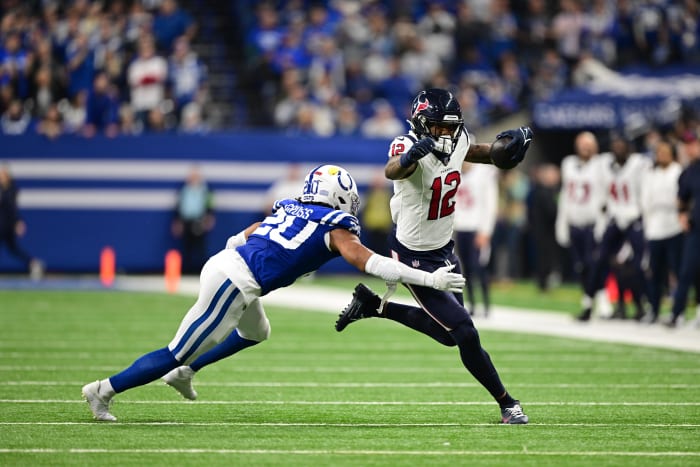 Texans' wide receiver Nico Collins runs against Indianapolis Colts safety Nick Cross (20) during the second quarter at Lucas Oil Stadium.